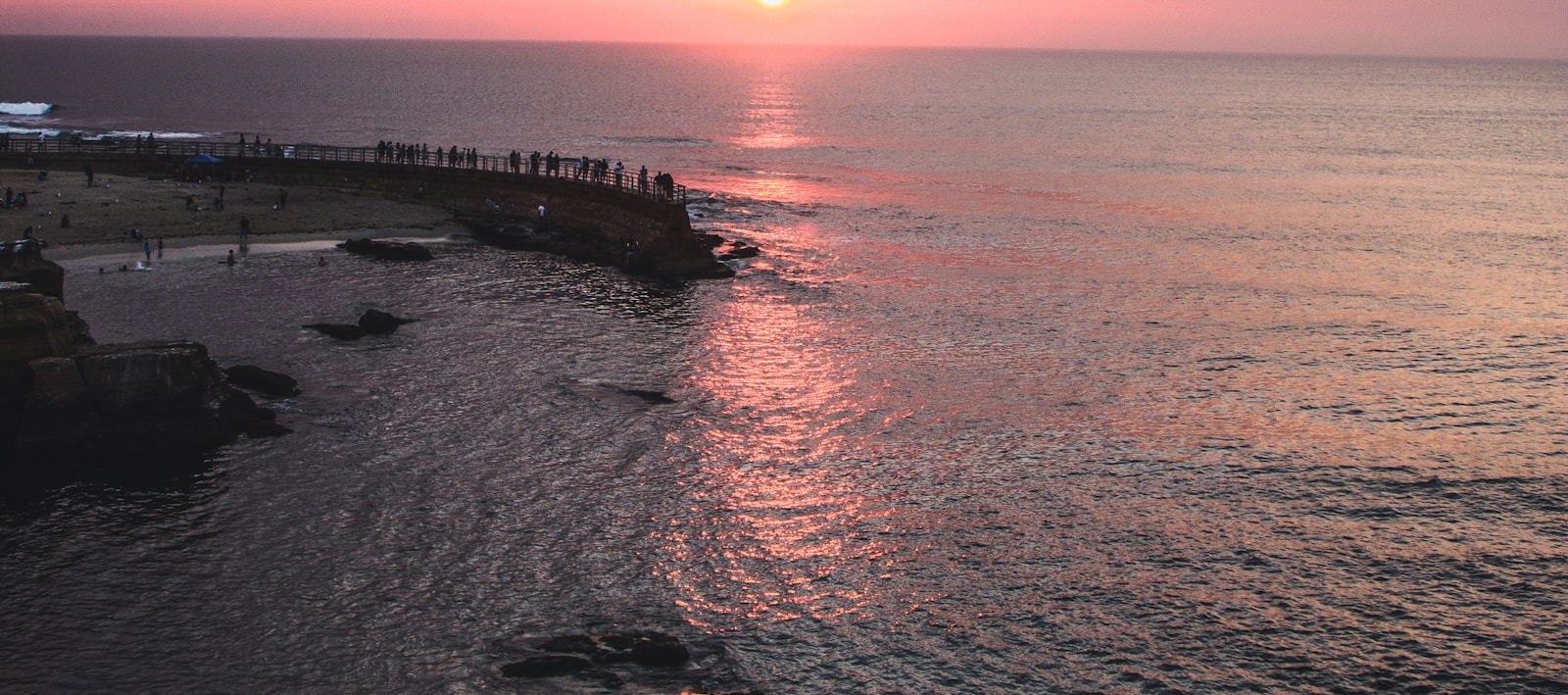 The sun low over the Pacific off Point Loma, the coastline in silhouette